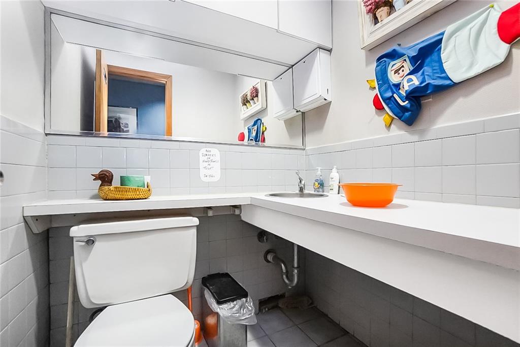 365 Bay Ridge Parkway Brooklyn, NY 11209 - Photo 7 of 33 a bathroom with a sink a stove and a refrigerator