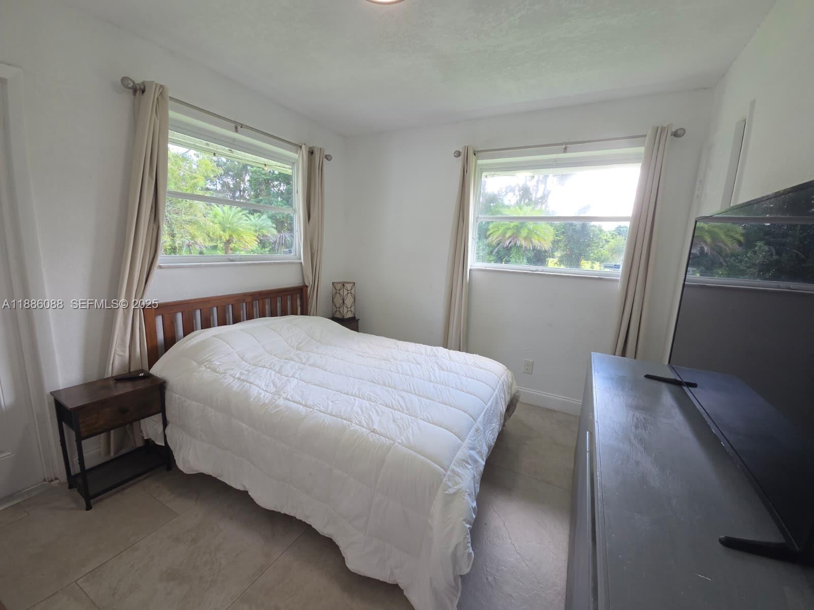 14001 Mustang Trail, Unit 1 Southwest Ranches, FL 33330 - Photo 12 of 31 a bedroom with a bed and a window