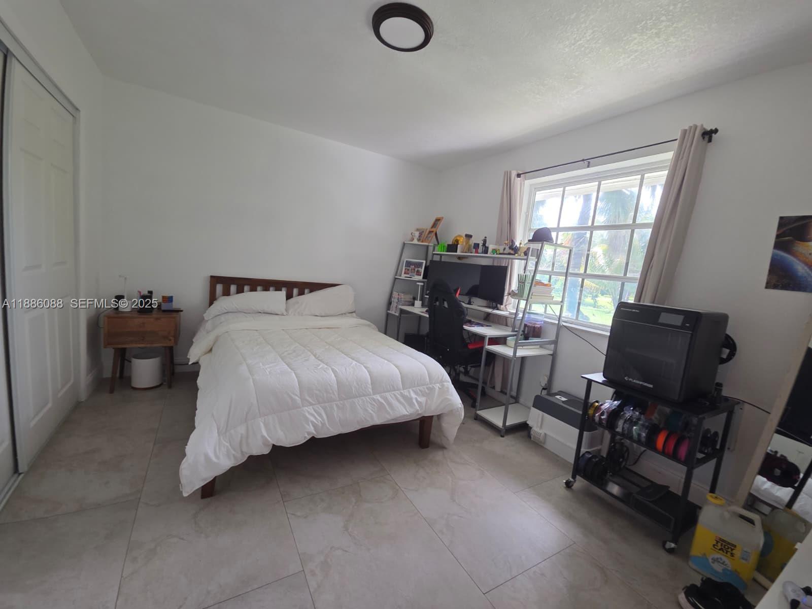 14001 Mustang Trail, Unit 1 Southwest Ranches, FL 33330 - Photo 14 of 31 a bedroom with a bed and a window