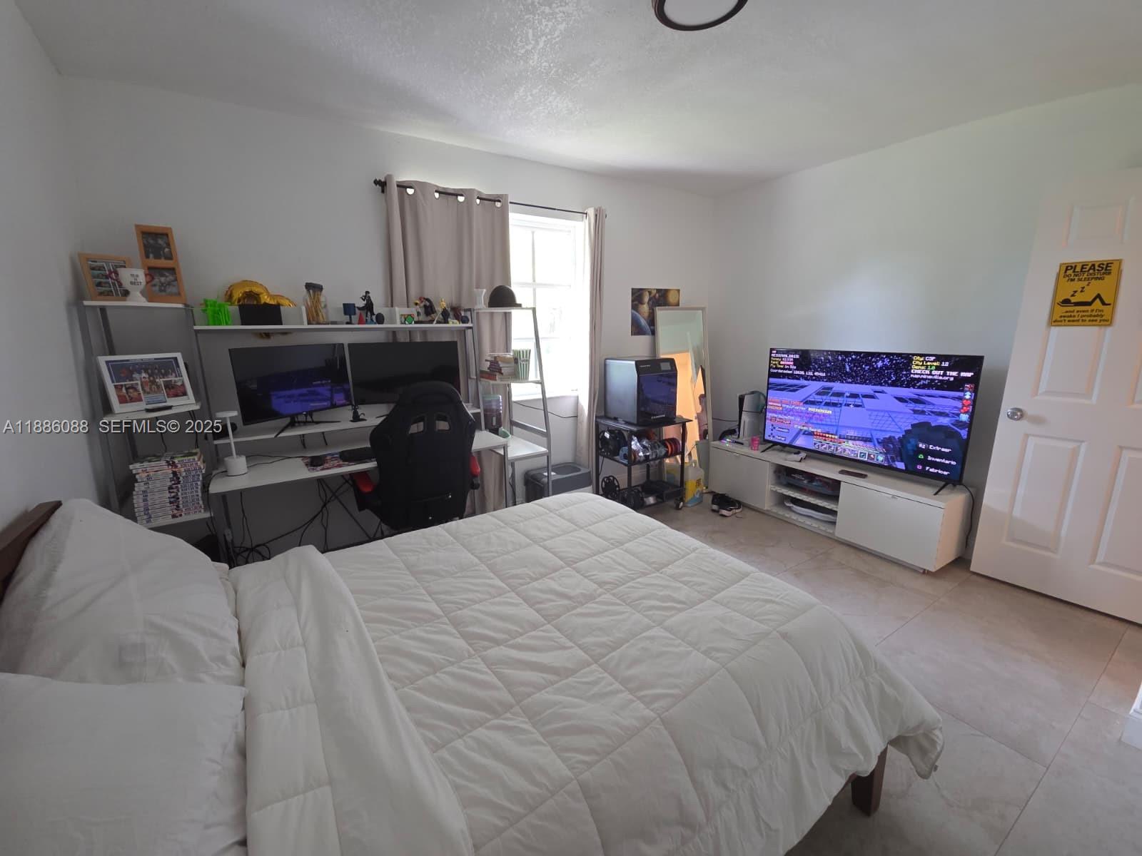 14001 Mustang Trail, Unit 1 Southwest Ranches, FL 33330 - Photo 15 of 31 a bedroom with a bed and furniture