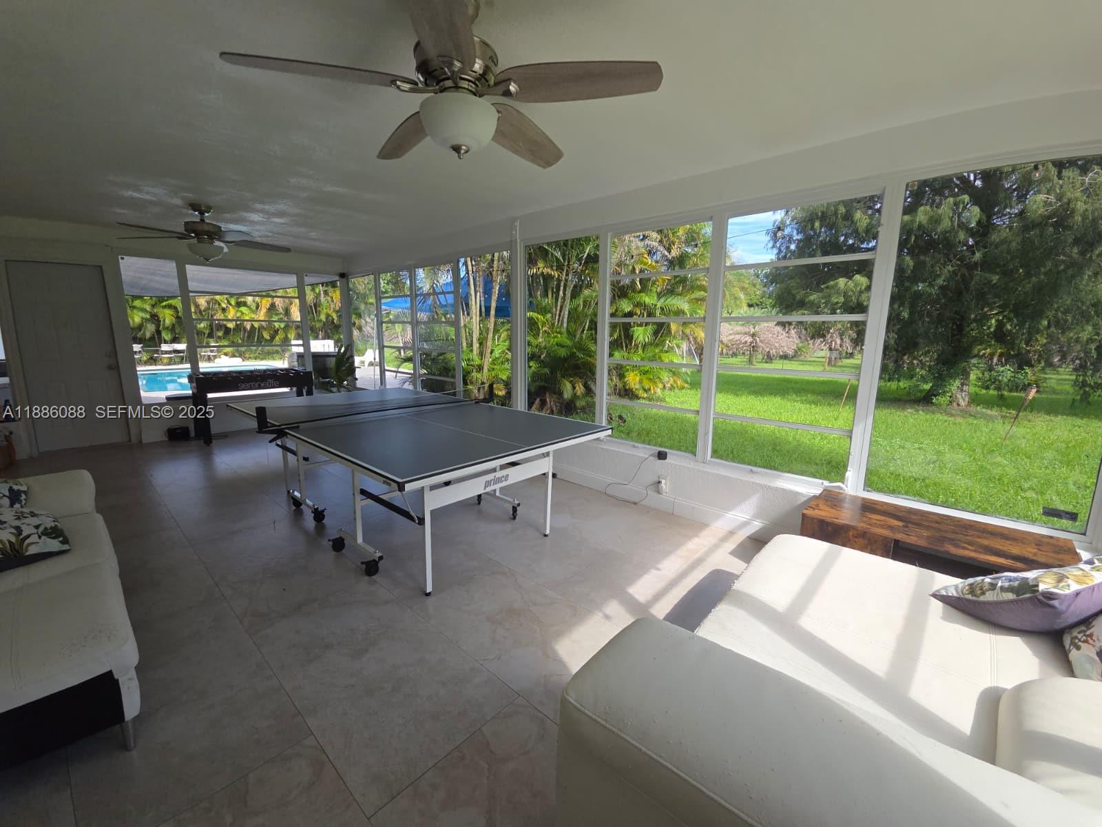 14001 Mustang Trail, Unit 1 Southwest Ranches, FL 33330 - Photo 16 of 31 a living room with pool table and a fireplace