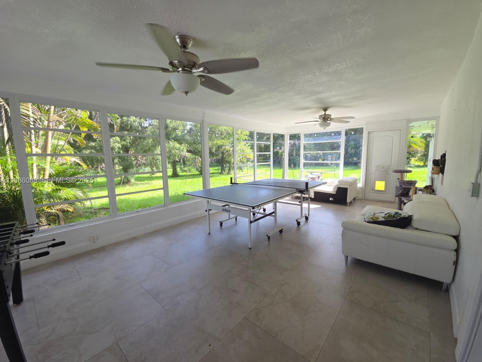14001 Mustang Trail, Unit 1 Southwest Ranches, FL 33330 - Photo 18 of 31 a living room with furniture and a large window