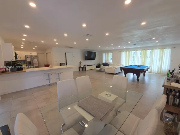 a kitchen with stainless steel appliances granite countertop a refrigerator sink and stove