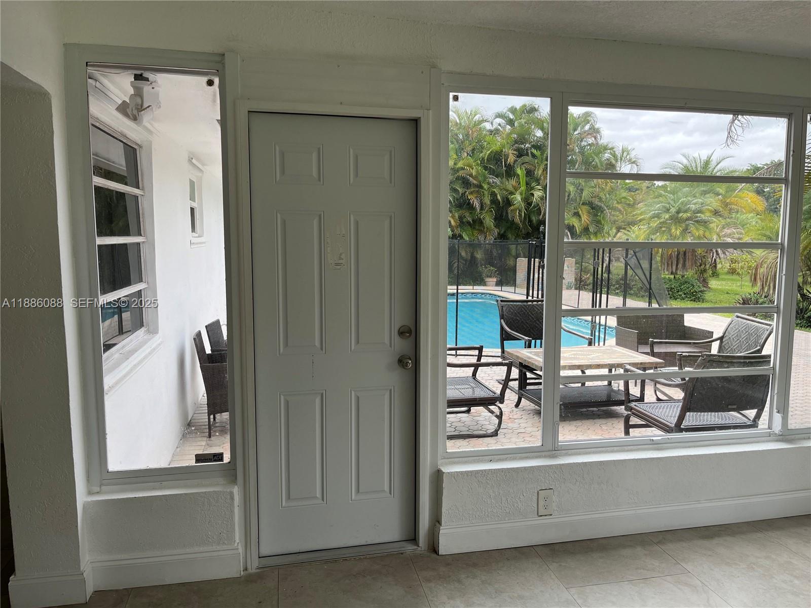 14001 Mustang Trail, Unit 1 Southwest Ranches, FL 33330 - Photo 4 of 31 a view of living room with furniture and large windows