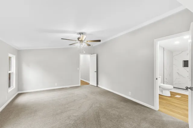 a view of an empty room with a fan