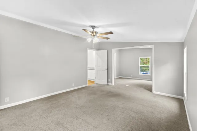 a view of an empty room with a ceiling fan