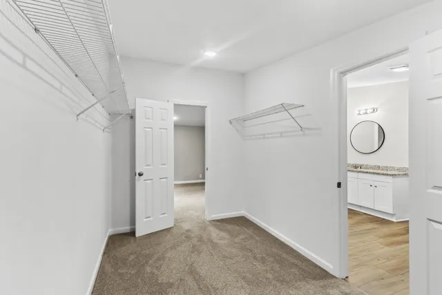 a bathroom with a granite countertop toilet sink and mirror