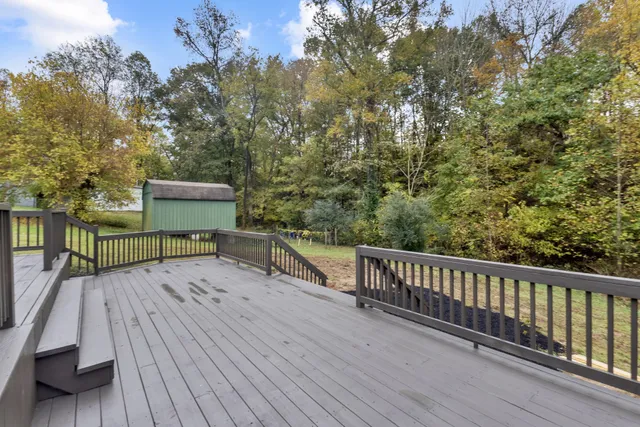 a view of a balcony with chairs and wooden floor