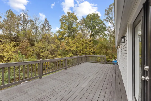 a view of balcony with wooden floor and fence