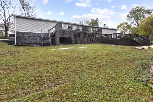 a view of backyard with wooden fence
