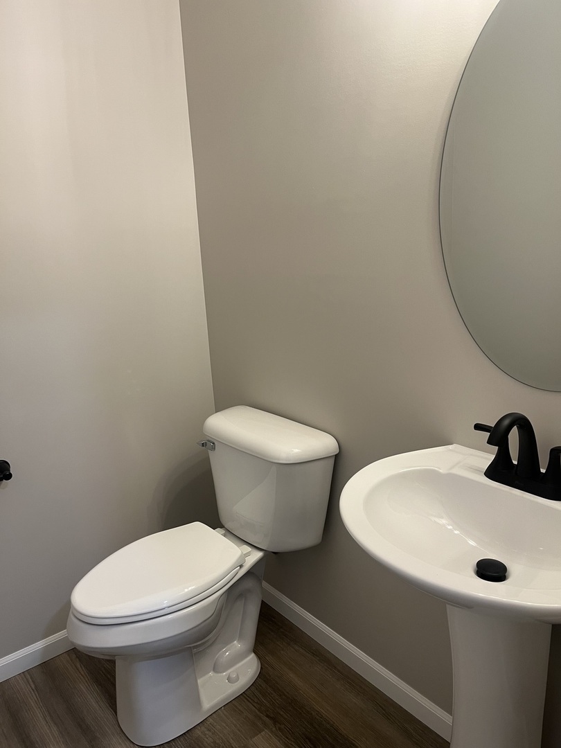 1321 Sioux Turn Kankakee, IL 60901 - Photo 14 of 34 a white toilet sitting next to a bathroom sink