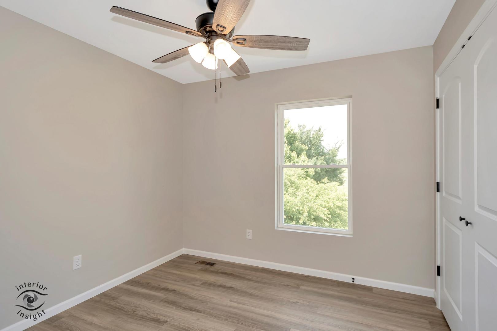 1321 Sioux Turn Kankakee, IL 60901 - Photo 16 of 34 an empty room with wooden floor fan and windows
