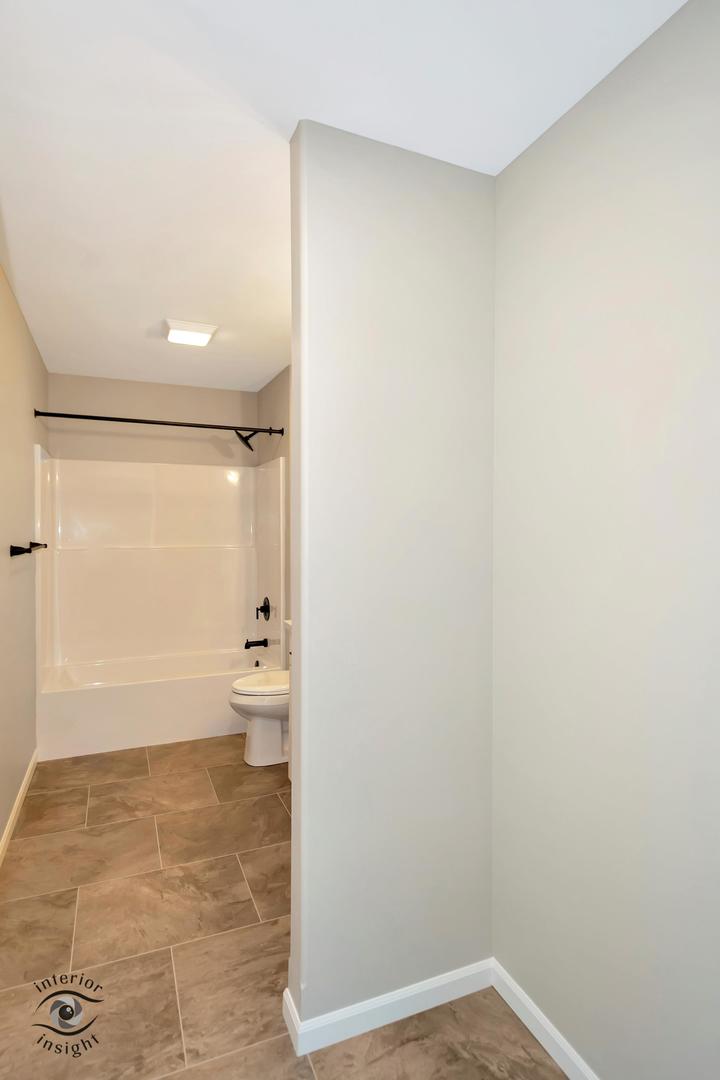 1321 Sioux Turn Kankakee, IL 60901 - Photo 20 of 34 a bathroom with a granite countertop toilet and a shower