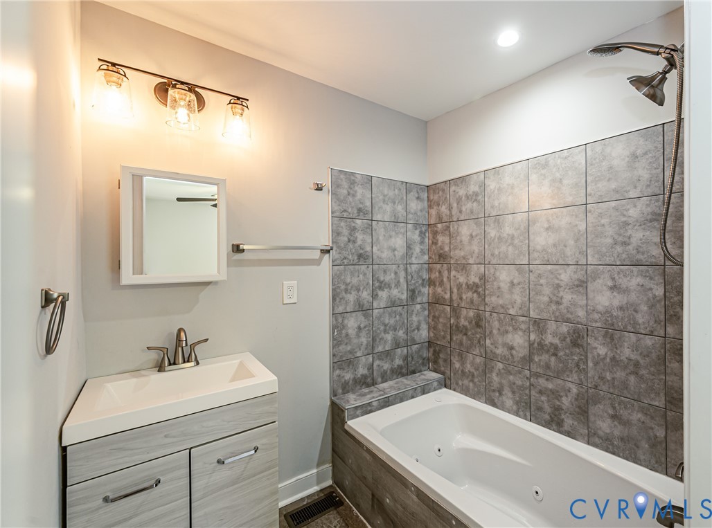 2015 Fordson Road Richmond, VA 23229 - Photo 26 of 48 Bathroom featuring a white jetted tub with dark gr