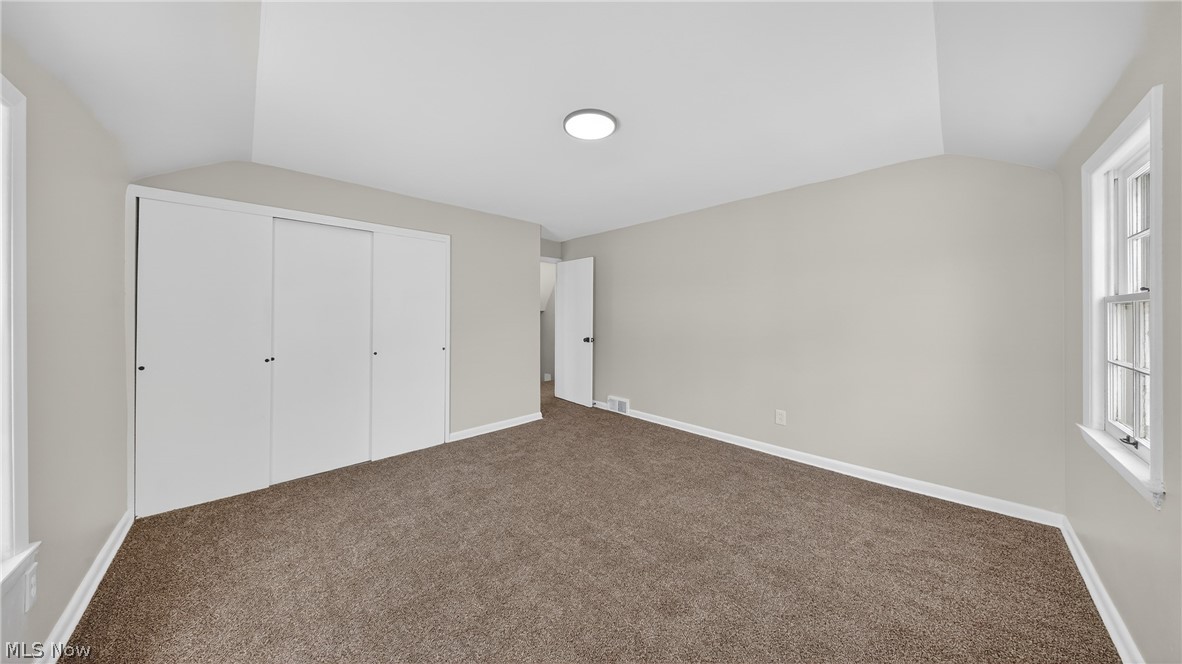 16811 Invermere Avenue Cleveland, OH 44128 - Photo 35 of 47 Unfurnished bedroom with lofted ceiling, carpet flooring, and a closet