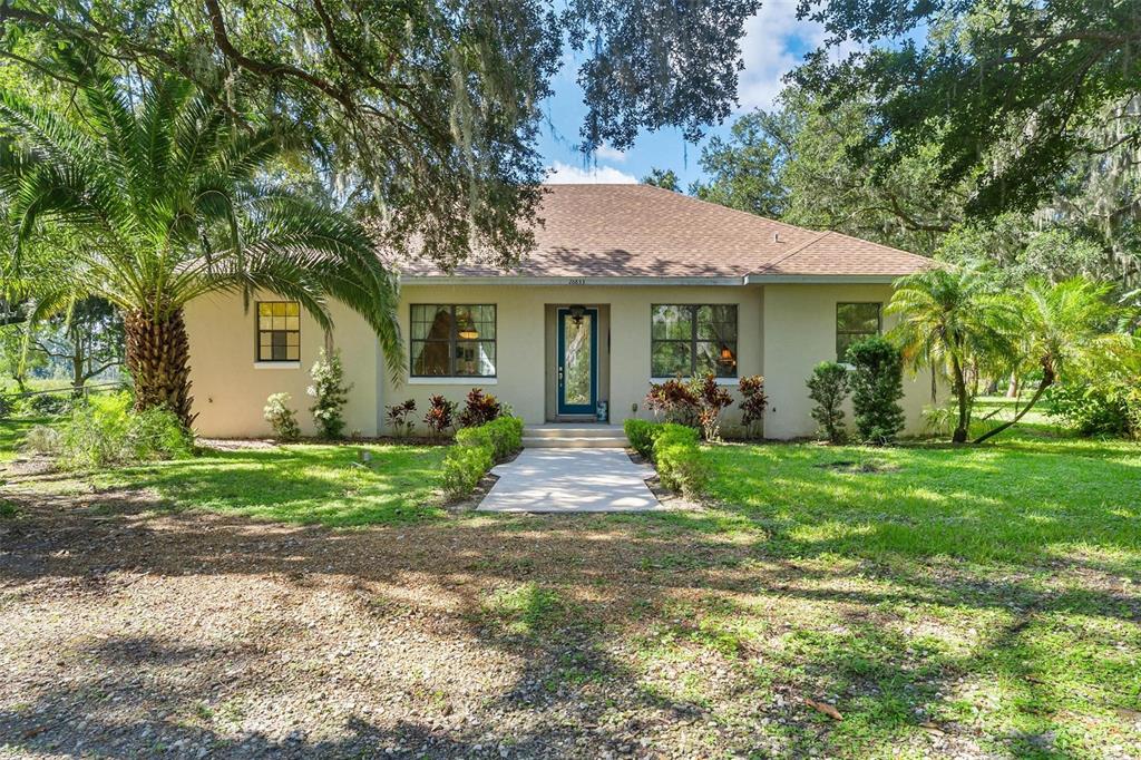 a front view of house with yard and green space