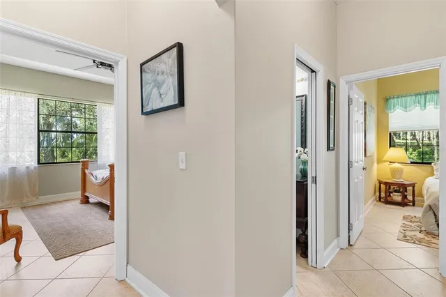 a view of a hallway with bathroom and wooden floor