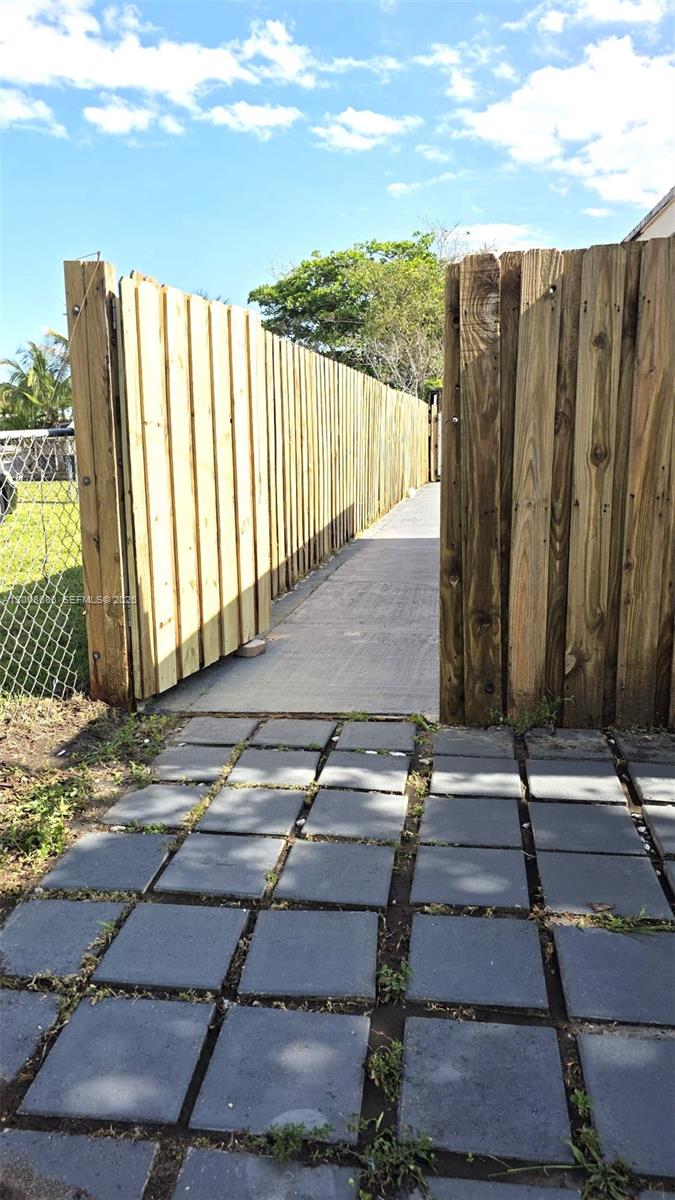 10790 Southwest 46th Street, Unit 10790 Miami, FL 33165 - Photo 14 of 19 a view of a backyard with wooden fence