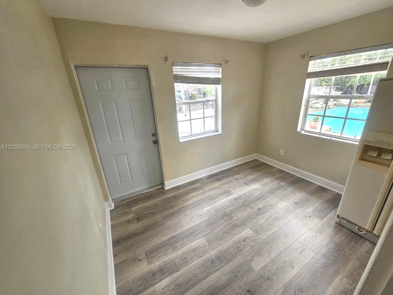 10790 Southwest 46th Street, Unit 10790 Miami, FL 33165 - Photo 2 of 19 a view of room with window and hardwood floor