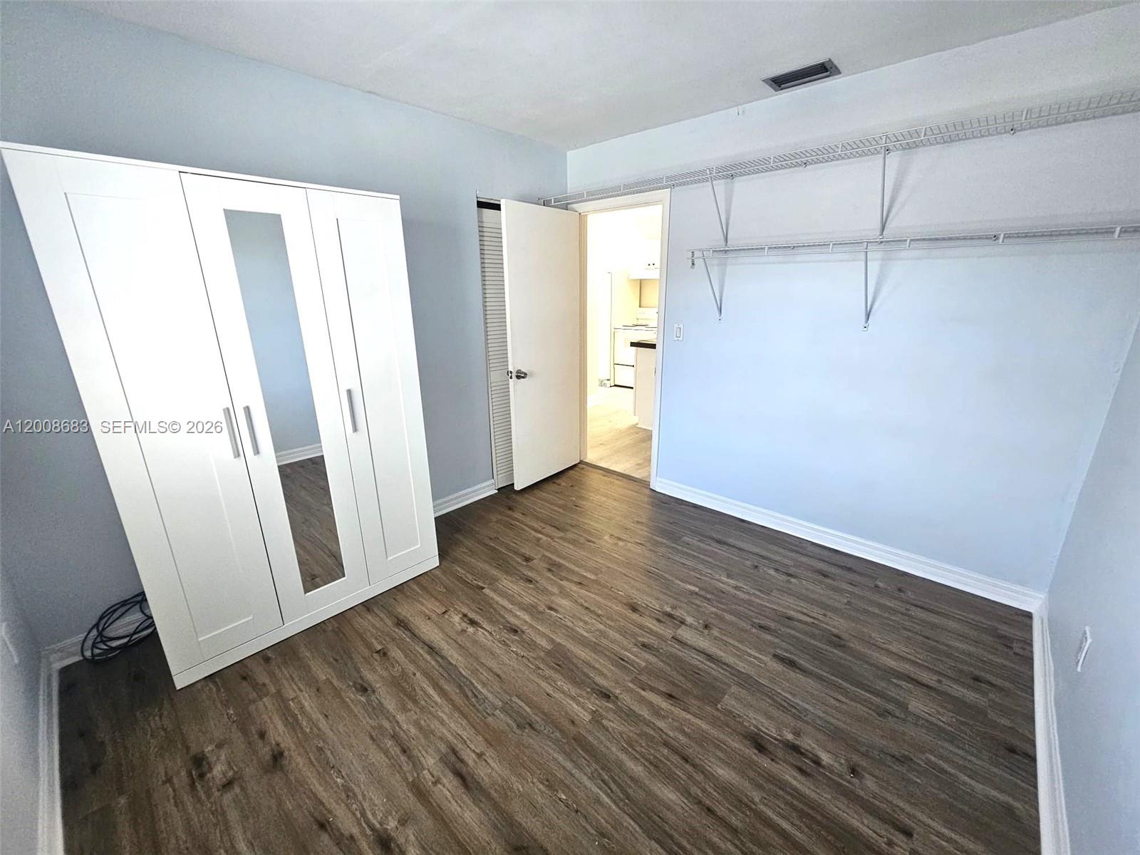 10790 Southwest 46th Street, Unit 10790 Miami, FL 33165 - Photo 5 of 19 a view of a room with wooden floors and led lights