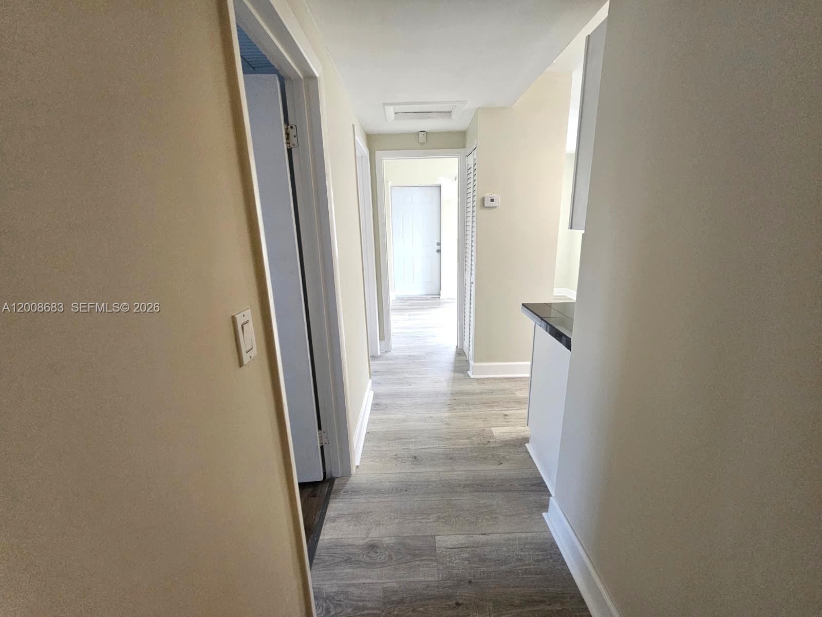10790 Southwest 46th Street, Unit 10790 Miami, FL 33165 - Photo 10 of 19 a view of a hallway with a wooden floor