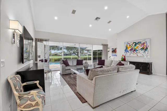 a bedroom with a bed flat screen tv and a window