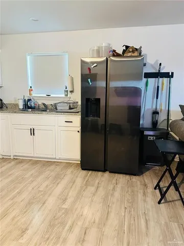 a kitchen with stainless steel appliances granite countertop a refrigerator a stove and a sink