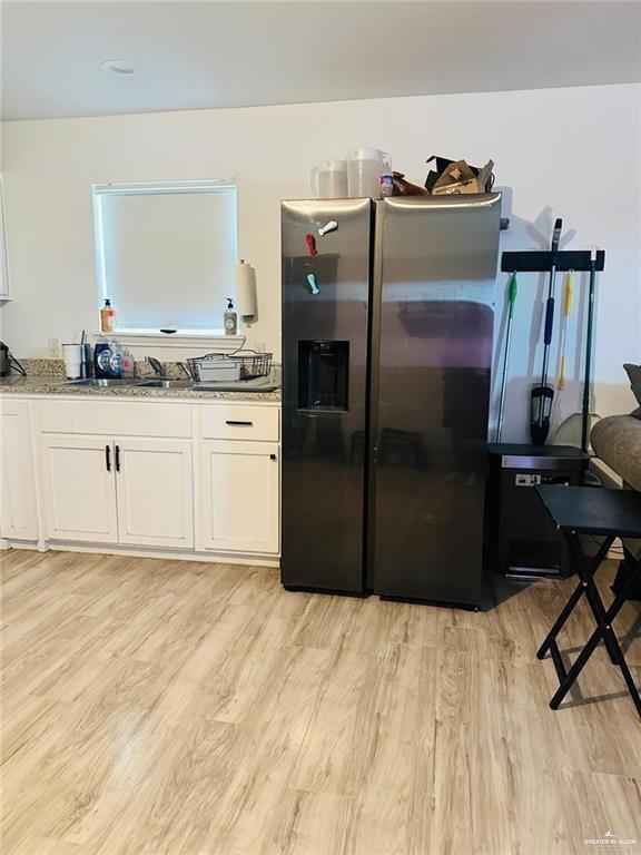 159 East Rodriguez Avenue Raymondville, TX 78580 - Photo 3 of 13 a kitchen with stainless steel appliances granite countertop a refrigerator a stove and a sink
