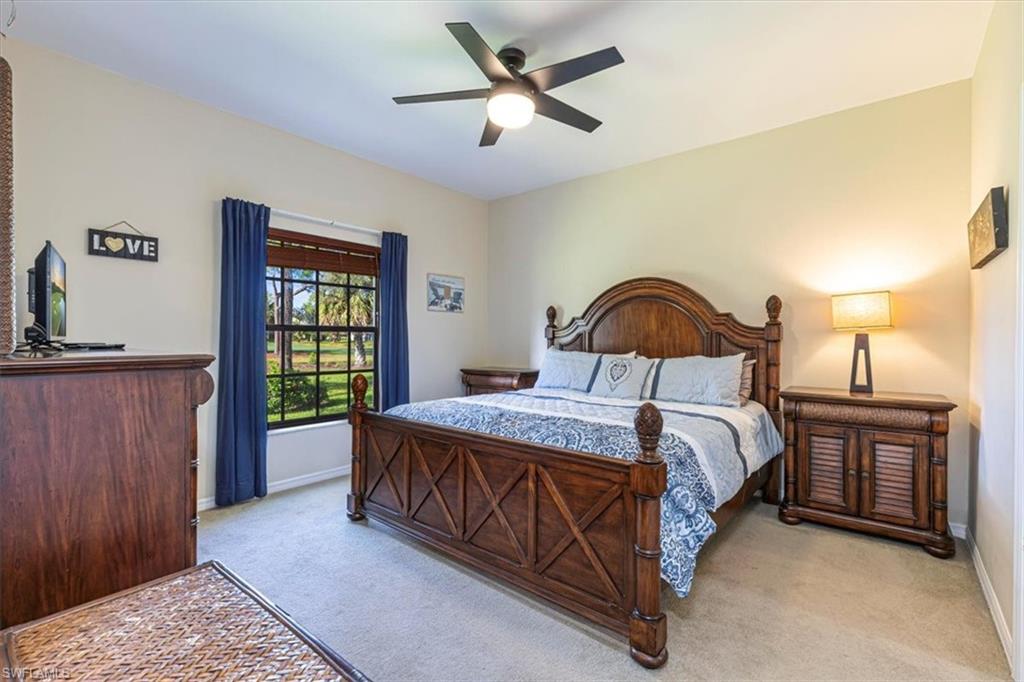 809 Augusta Boulevard, Unit 3 Naples, FL 34113 - Photo 19 of 32 Bedroom with light colored carpet and a ceiling fan
