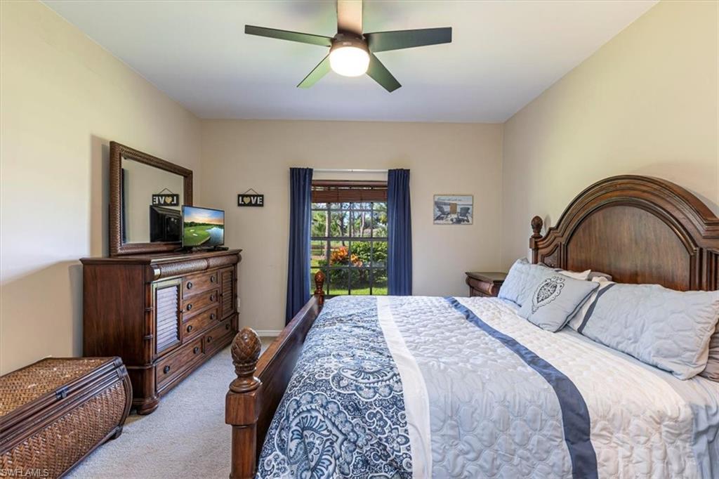 809 Augusta Boulevard, Unit 3 Naples, FL 34113 - Photo 20 of 32 Carpeted bedroom with ceiling fan