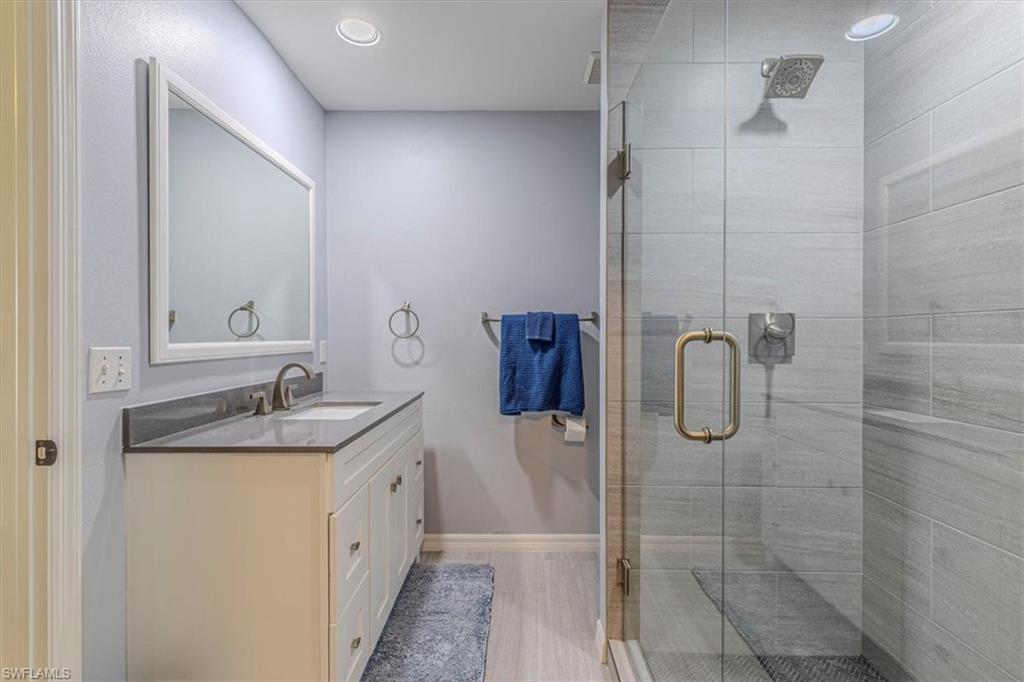 809 Augusta Boulevard, Unit 3 Naples, FL 34113 - Photo 23 of 32 Bathroom featuring vanity, a stall shower, and recessed lighting