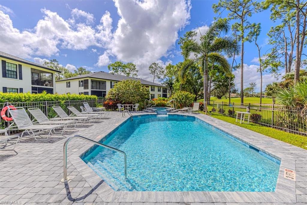 809 Augusta Boulevard, Unit 3 Naples, FL 34113 - Photo 29 of 32 View of pool featuring a patio area and a pool with connected hot tub