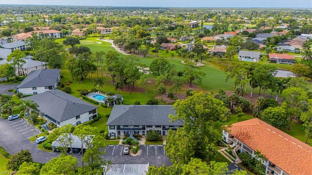 809 Augusta Boulevard, Unit 3 Naples, FL 34113 - Photo 3 of 32 Aerial perspective of suburban area featuring a golf course