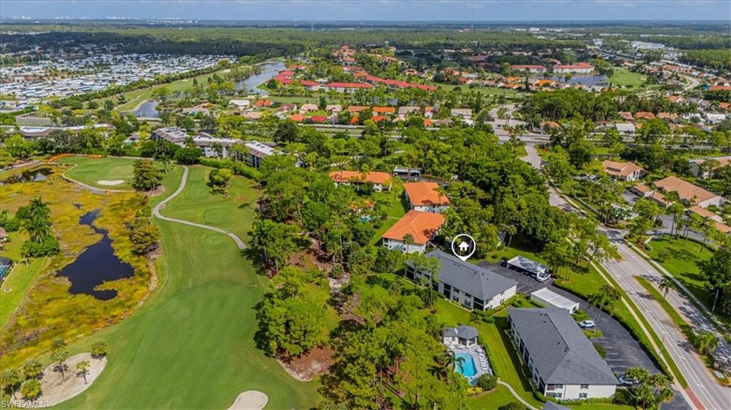 809 Augusta Boulevard, Unit 3 Naples, FL 34113 - Photo 4 of 32 Aerial view of property and surrounding area featuring a large body of water and nearby suburban area