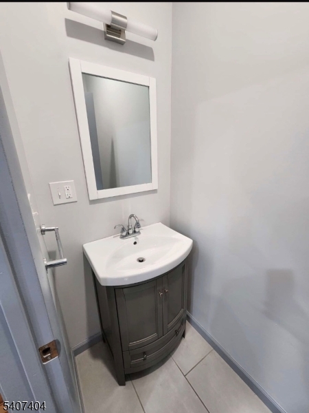296 Chadwick Avenue Newark, NJ 07112 - Photo 11 of 12 a bathroom with a sink a mirror and vanity