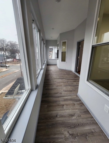 296 Chadwick Avenue Newark, NJ 07112 - Photo 4 of 12 a view of a hallway with wooden floor and stairs
