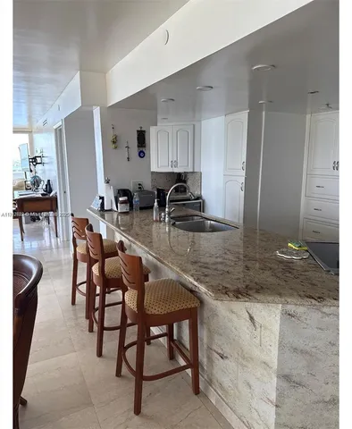 a bed sitting in a bedroom and chair