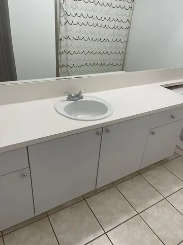 a bathroom with a toilet and a shower curtain