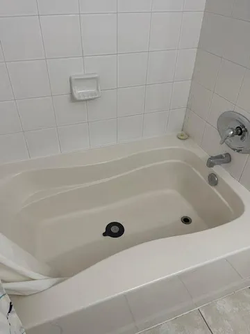 a bathroom with a shower and a bathtub