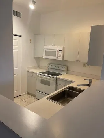 a kitchen that has a sink and a stove