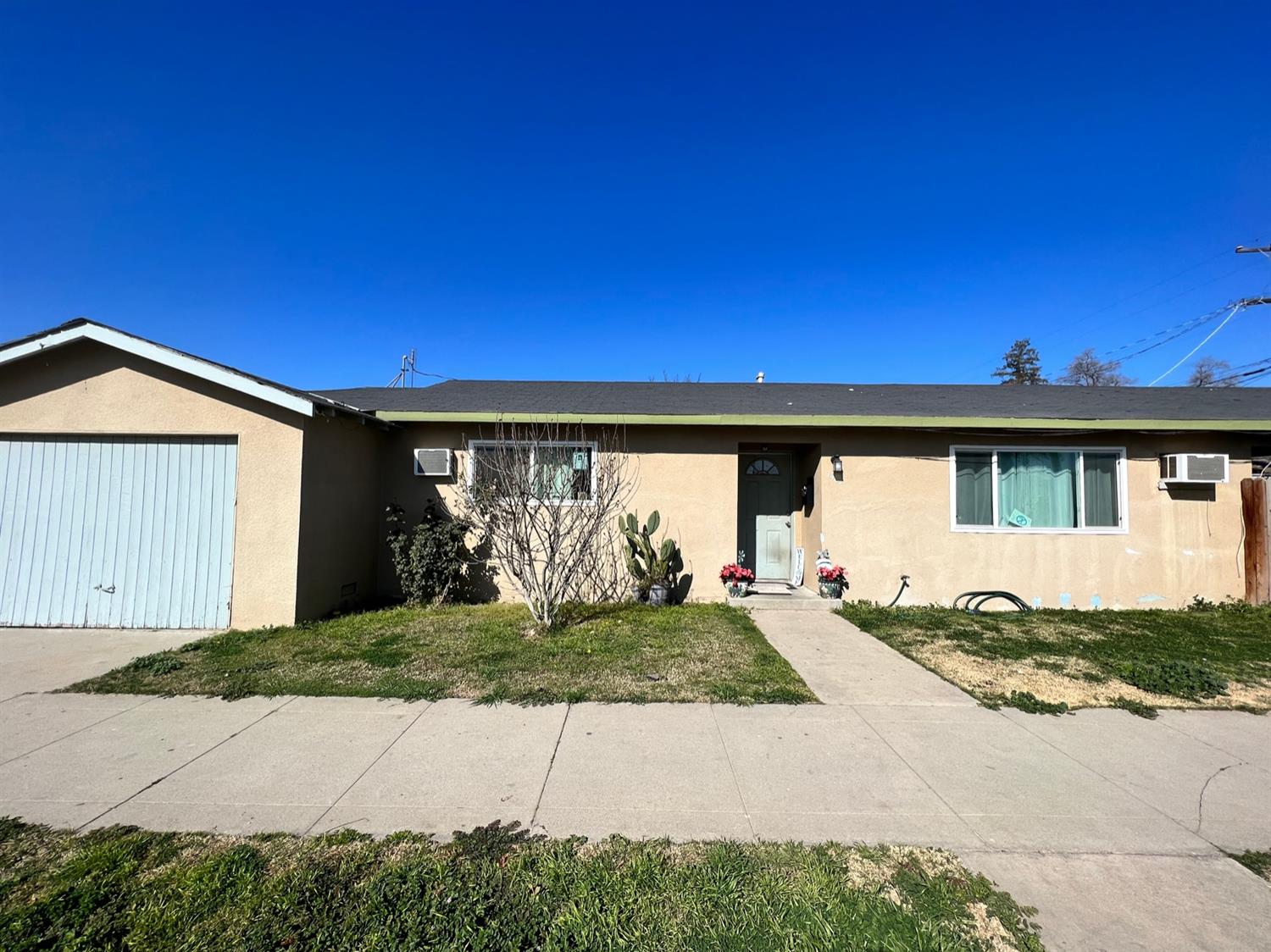 1258 E Street Reedley, CA 93654 - Photo 1 of 1 a front view of a house with a yard