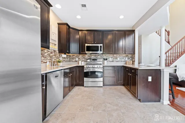 a large kitchen with a stove and cabinets