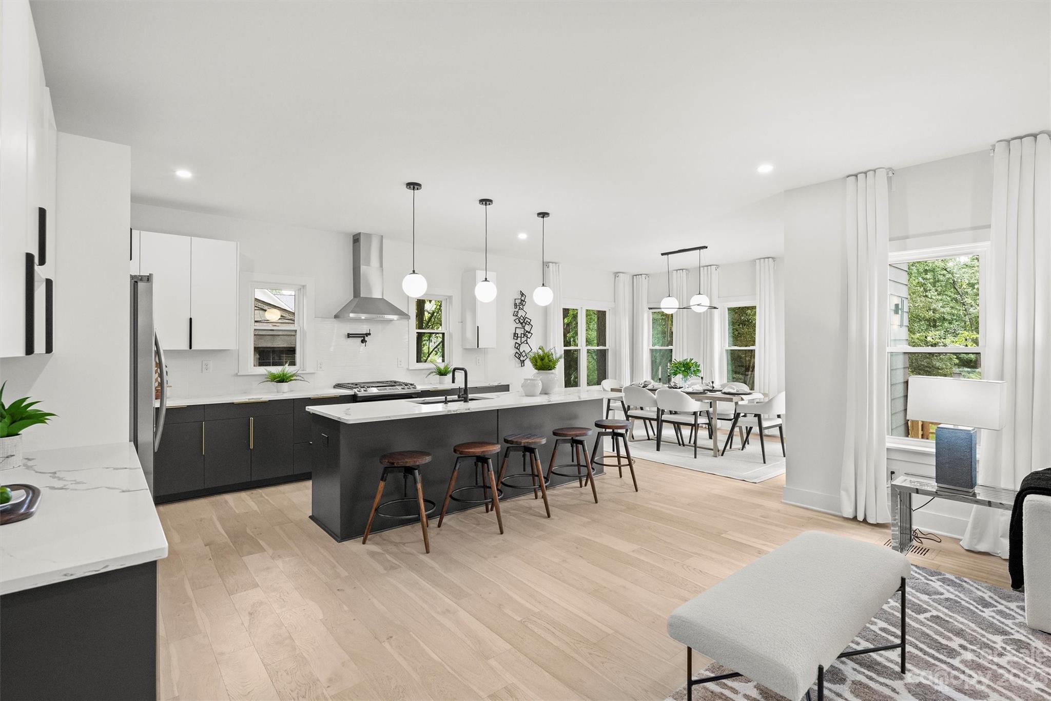 1608 Chippendale Road Charlotte, NC 28205 - Photo 11 of 34 a large dining hall with stainless steel appliances granite countertop a stove a sink a dining table and chairs