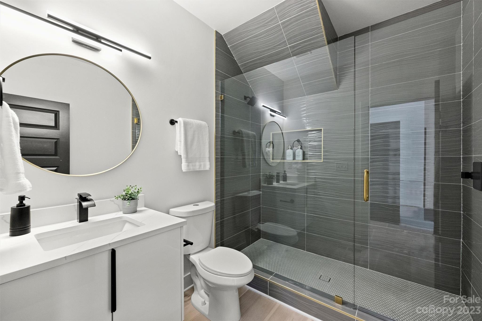 1608 Chippendale Road Charlotte, NC 28205 - Photo 18 of 34 a bathroom with a sink a toilet and shower
