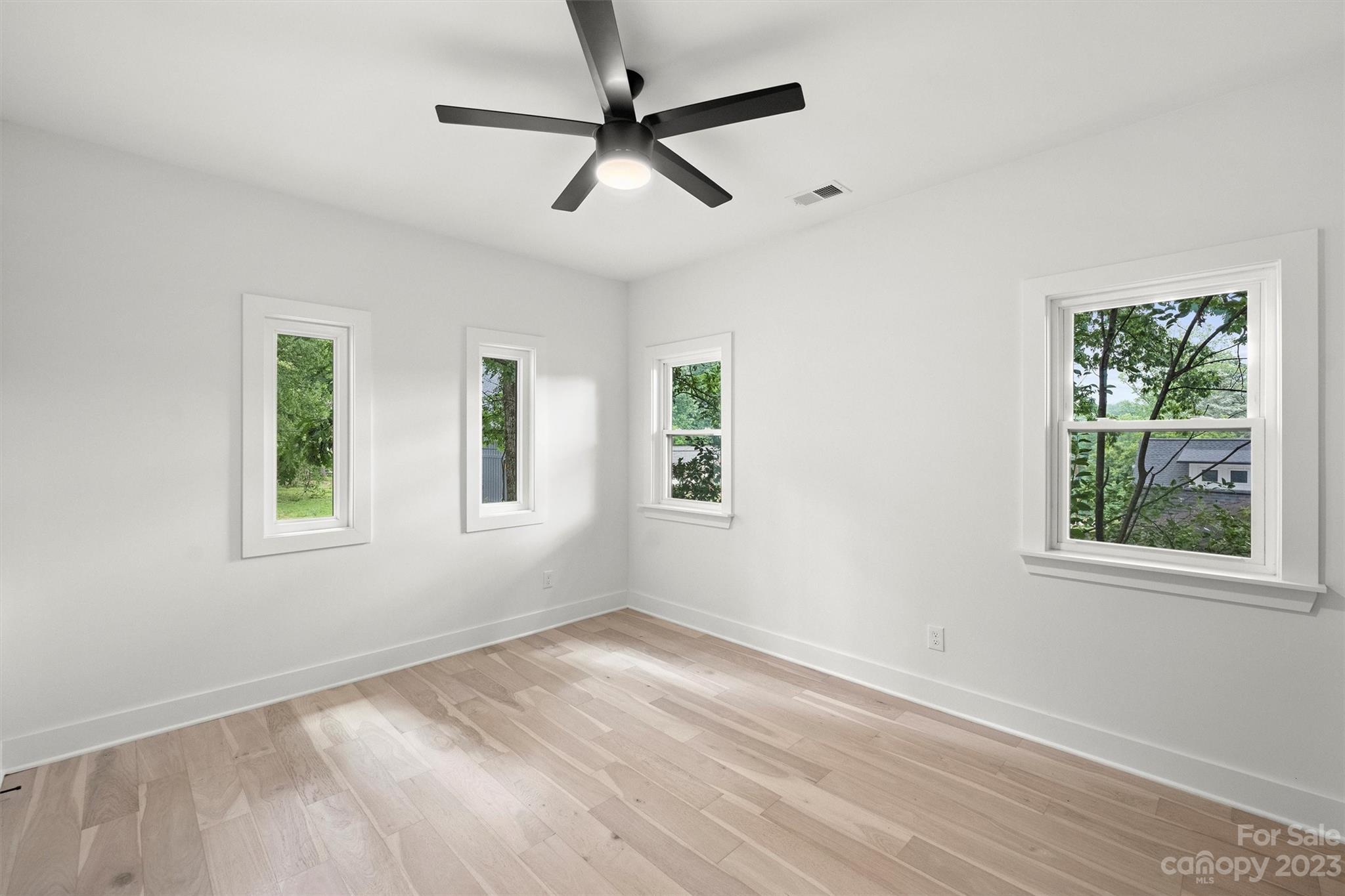 1608 Chippendale Road Charlotte, NC 28205 - Photo 29 of 34 a view of empty room with wooden floor and fan