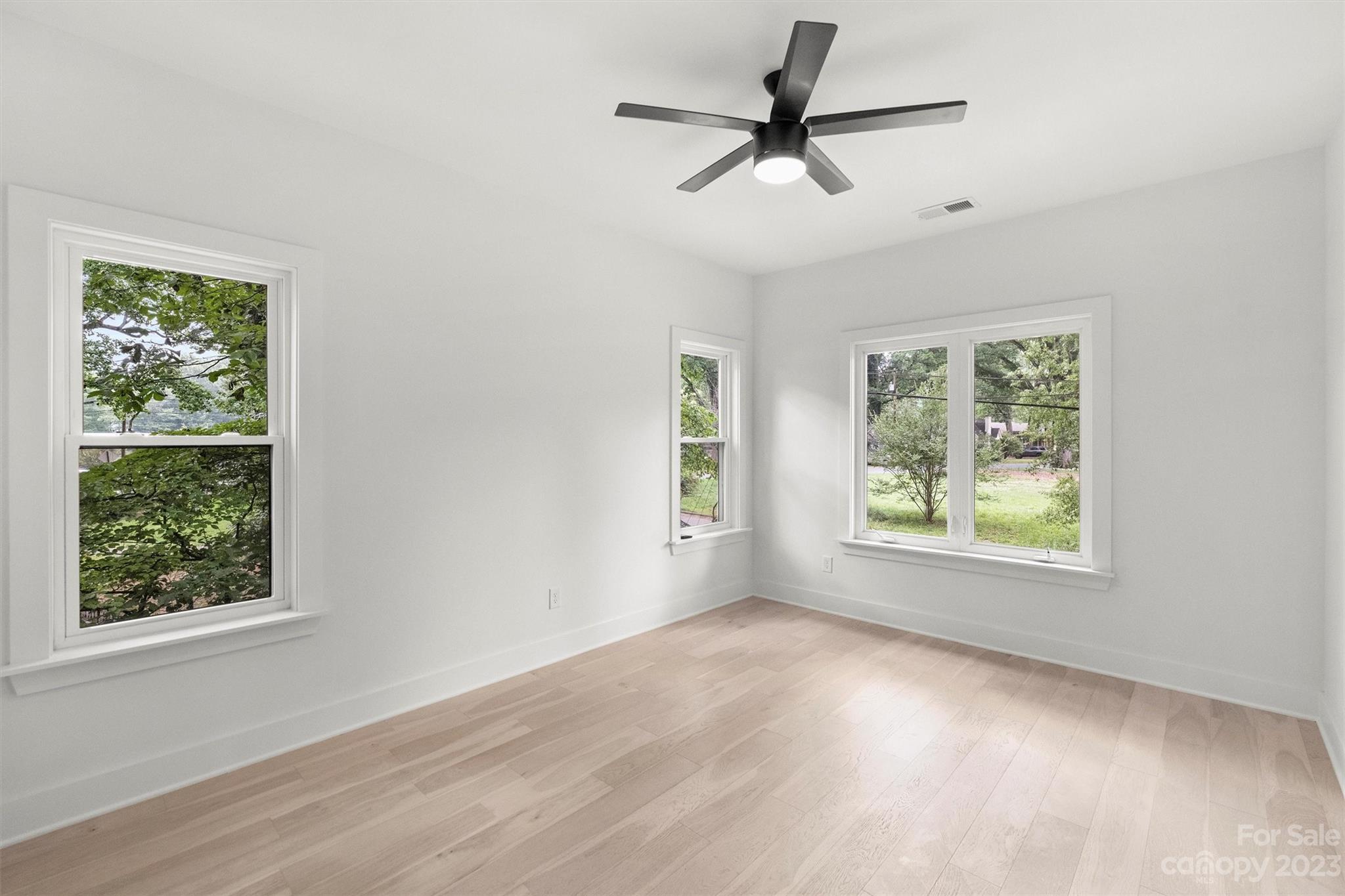 1608 Chippendale Road Charlotte, NC 28205 - Photo 30 of 34 a view of a livingroom with a window a ceiling fan and wooden floor