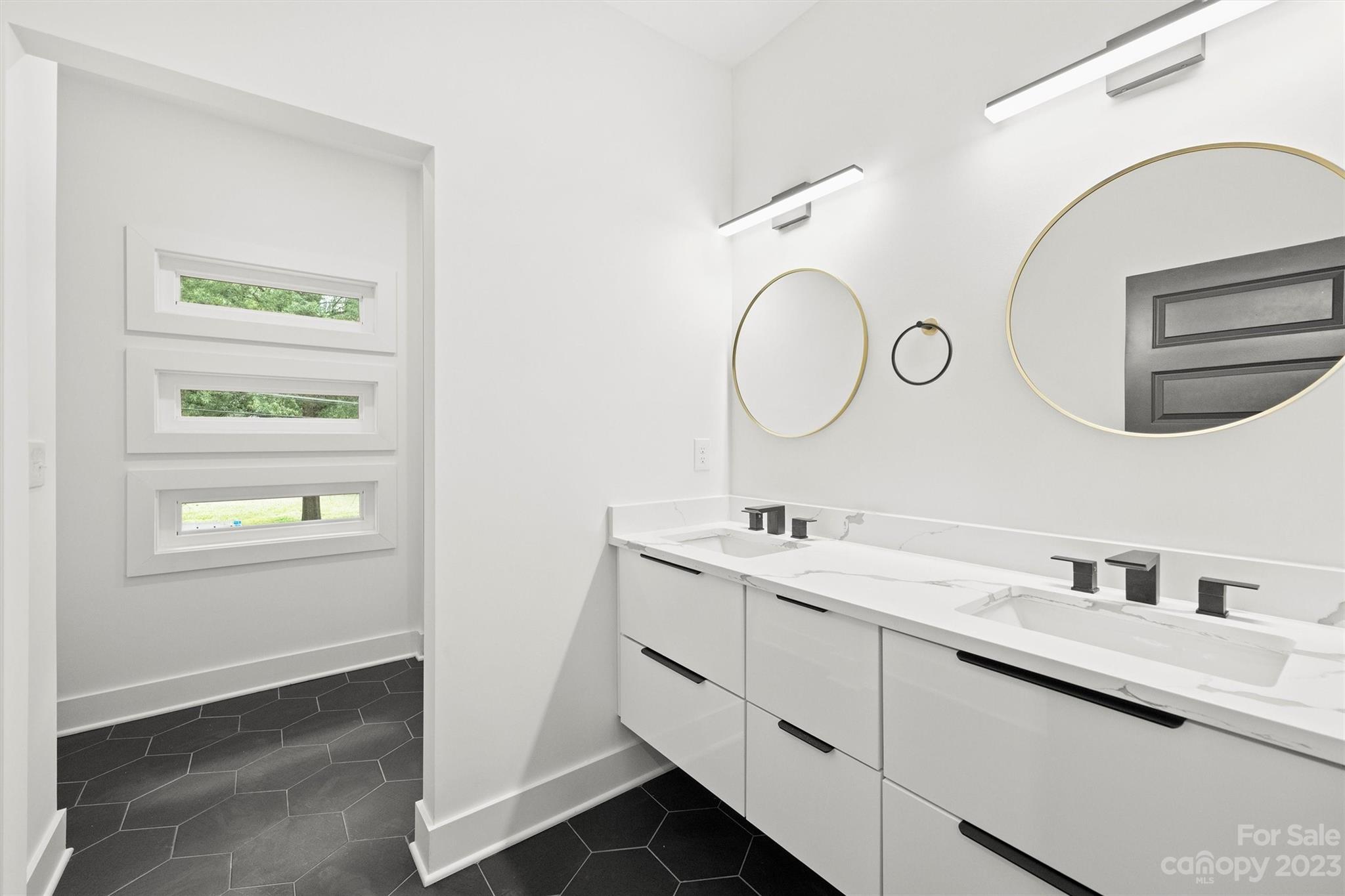 1608 Chippendale Road Charlotte, NC 28205 - Photo 31 of 34 a bathroom with a double vanity sink and a window