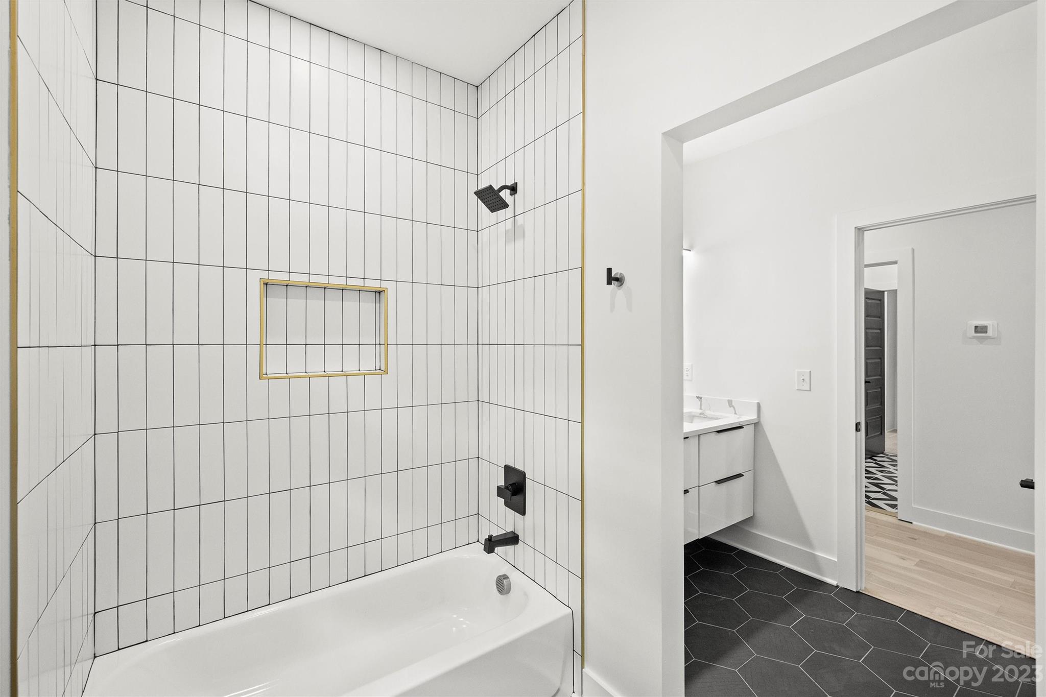 1608 Chippendale Road Charlotte, NC 28205 - Photo 32 of 34 a bathroom with a bathtub and shower