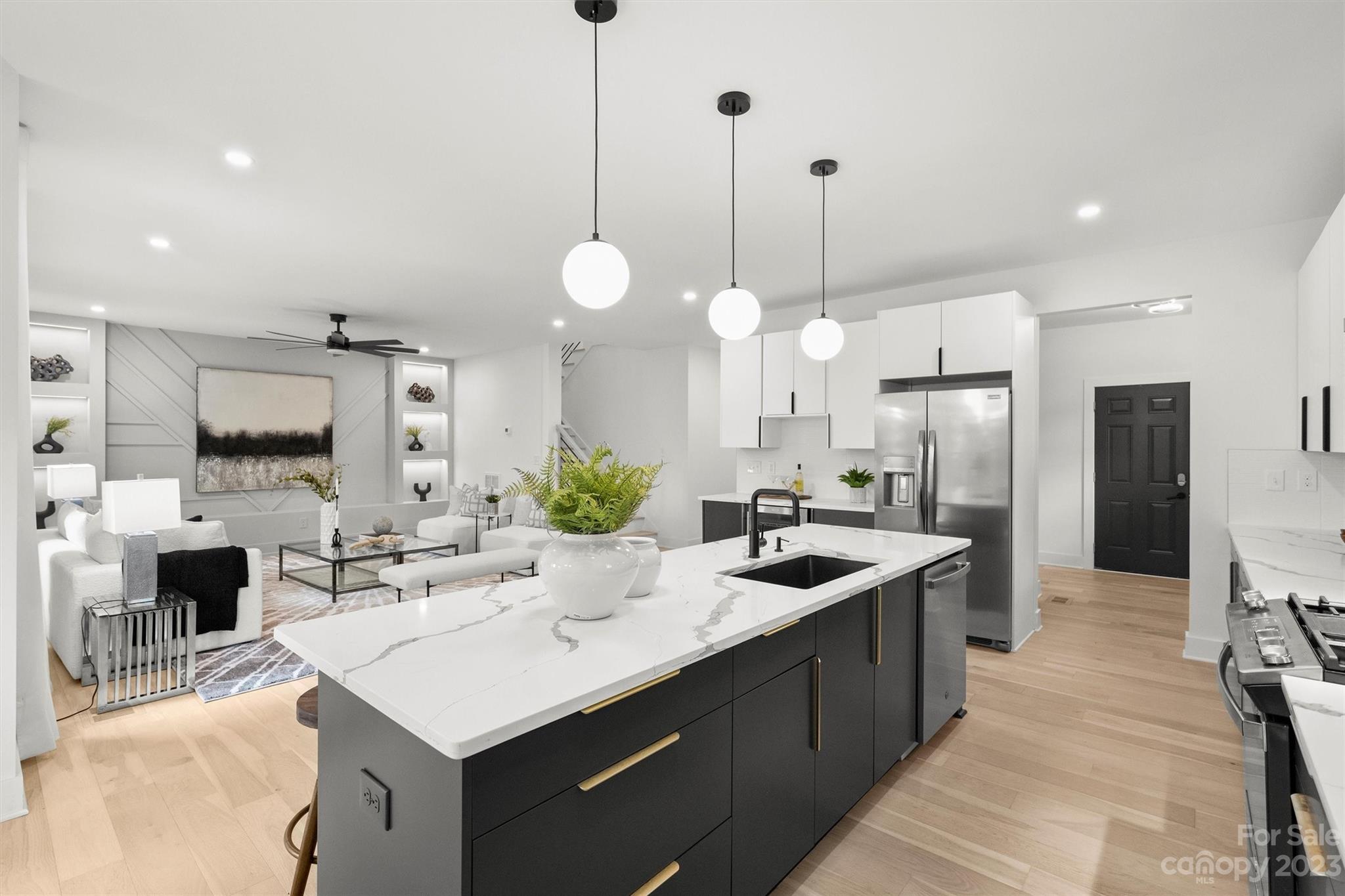1608 Chippendale Road Charlotte, NC 28205 - Photo 6 of 34 a kitchen with stainless steel appliances kitchen island granite countertop a sink a stove a refrigerator a kitchen island with a dining table and chairs