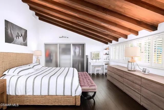 a bedroom with a bed and a desk